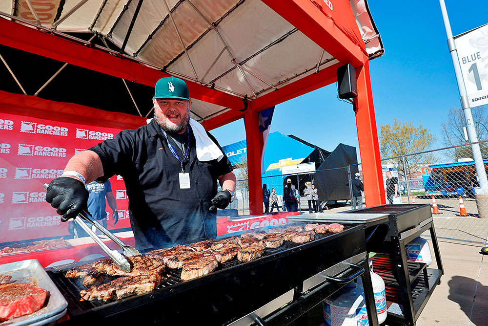 A chef grills meat
