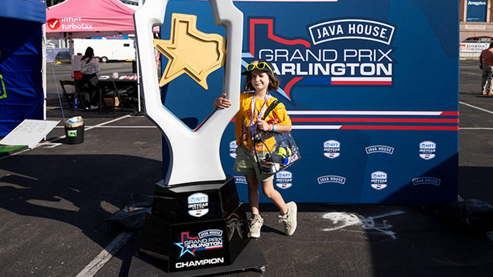 A child poses with the trophy