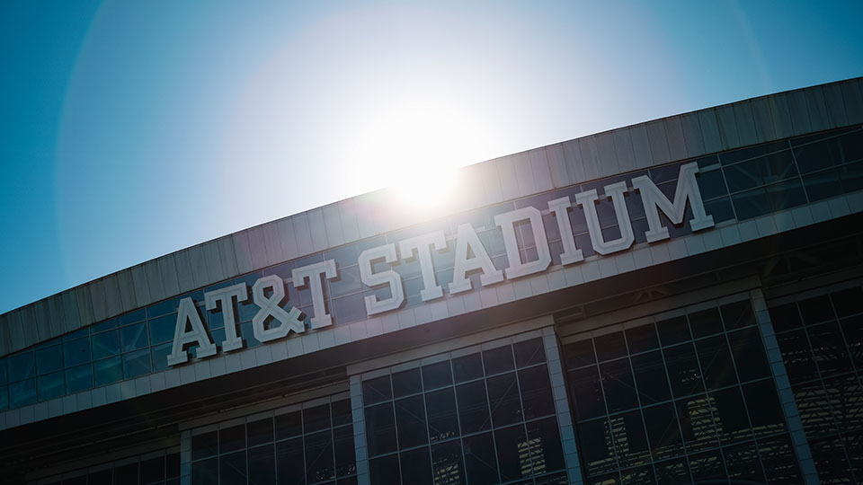 The sun rises over AT&T Stadium
